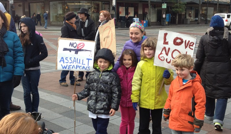 Sign held by a child at Seattle rally reads "No assault weapons"