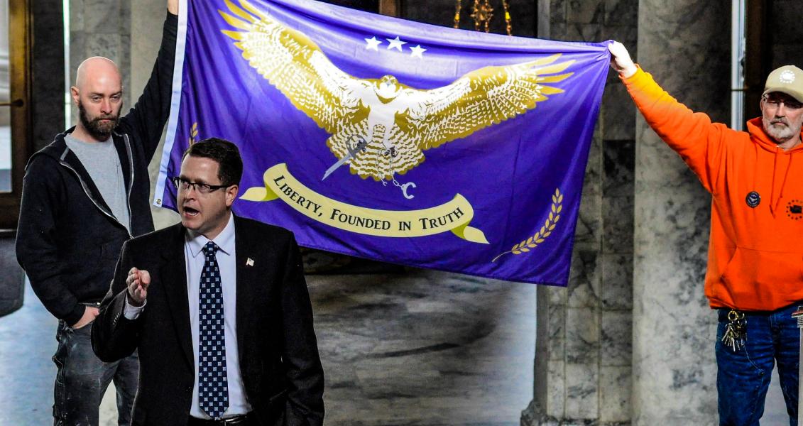 GOP Rep. Matt Shea in front of a Liberty flag
